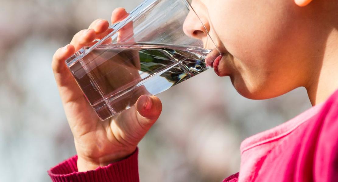 Child drinking a glass of clean water