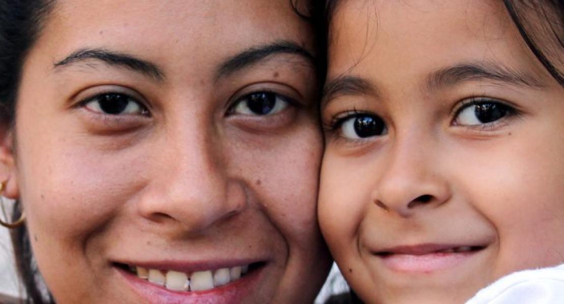 woman holding smiling child