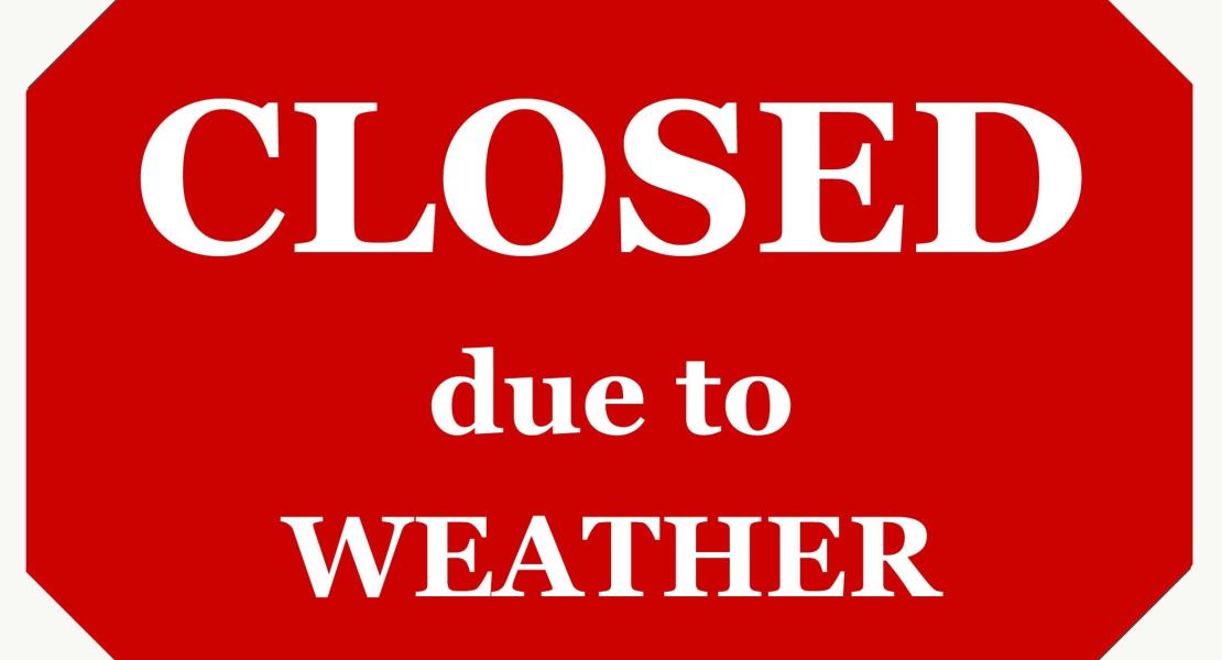 Red Octagon Sign That Reads Closed due to Weather