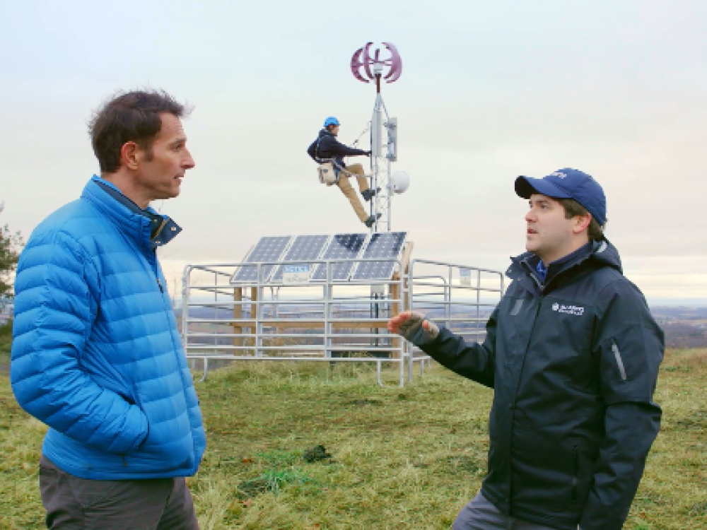 Two men talking in a field